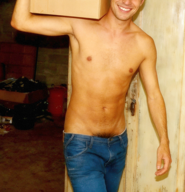 The shirtless cleaner with his pants sagging and pubes peeking carrying a box.